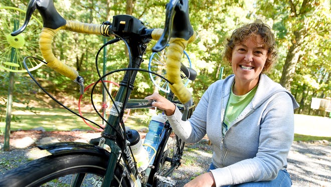 Beth Ann Hinnant of Staunton enjoys exploring the country from the seat of her bicycle. She is photographed with her bike outside her home on Monday, Oct. 5, 2015.