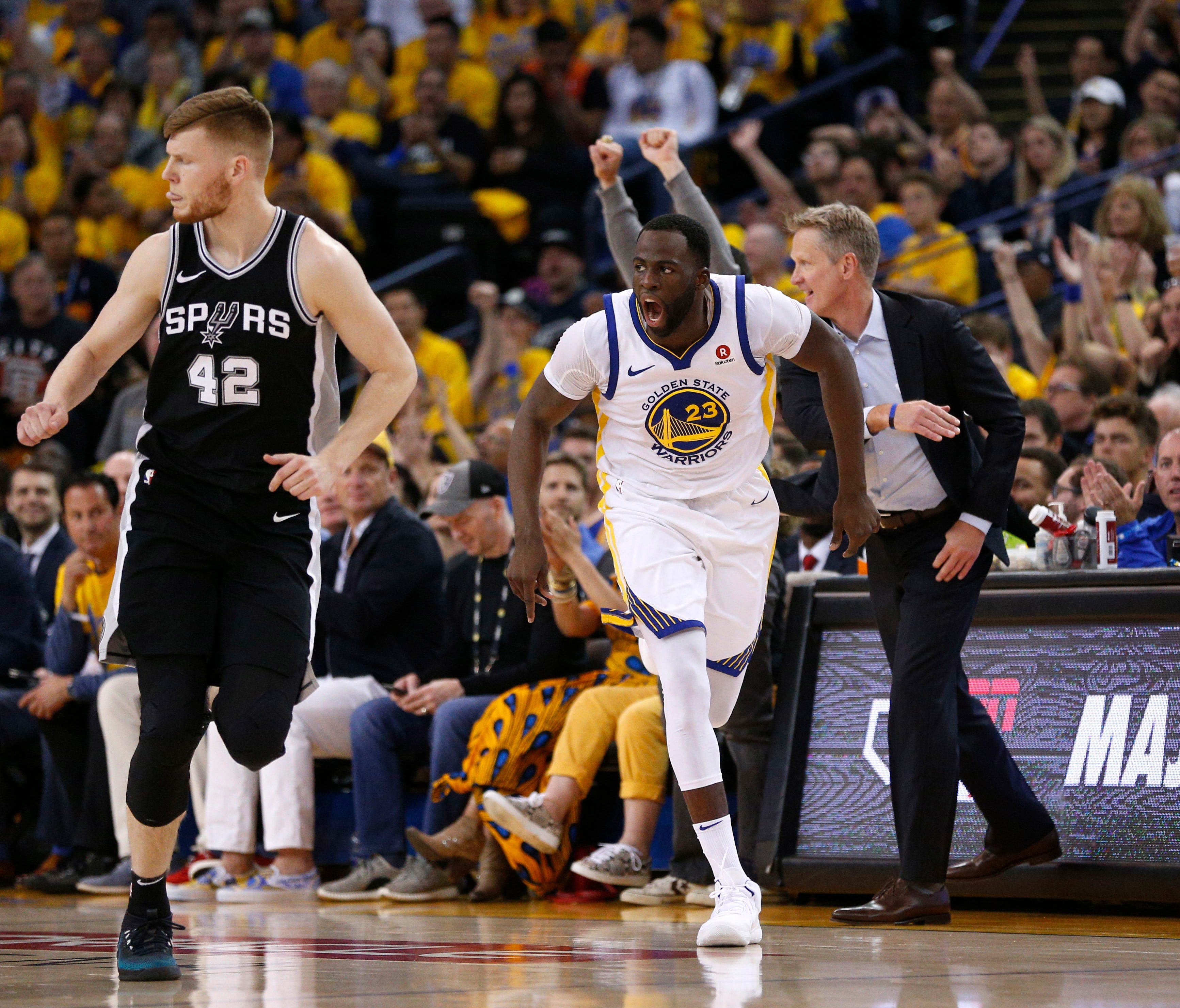 Golden State Warriors forward Draymond Green (23) reacts after making a three point basket against the San Antonio Spurs in the third quarter in game one of the first round of the 2018 NBA Playoffs at Oracle Arena.
