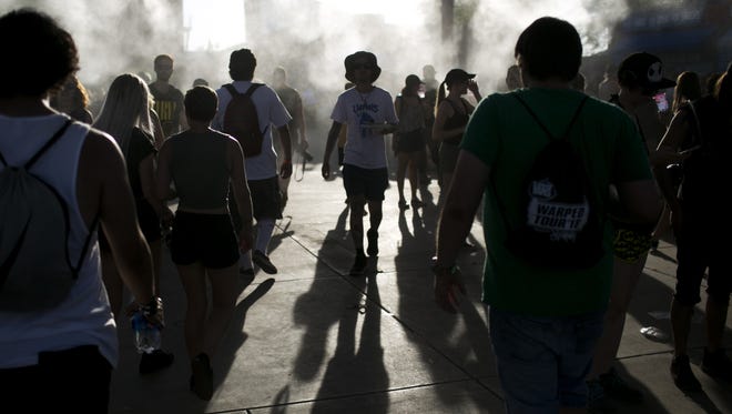 Fans walk through misters in the heat at the 2018 Vans Warped Tour at Ak-Chin Pavilion on June 28, 2018 in Phoenix. The festival, which was started in 1995, announced this would be its final run.
