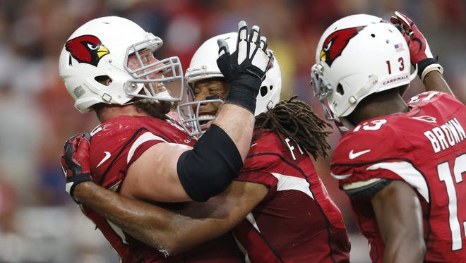 Arizona Cardinals WR Larry Fitzgerald celebrates his touchdown against the San Francisco 49ers with guard Ted Larsen (left) and WR Jaron Brown (13) in the fourth quarter during NFL action at University of Phoenix Stadium in Glendale September 27, 2015.