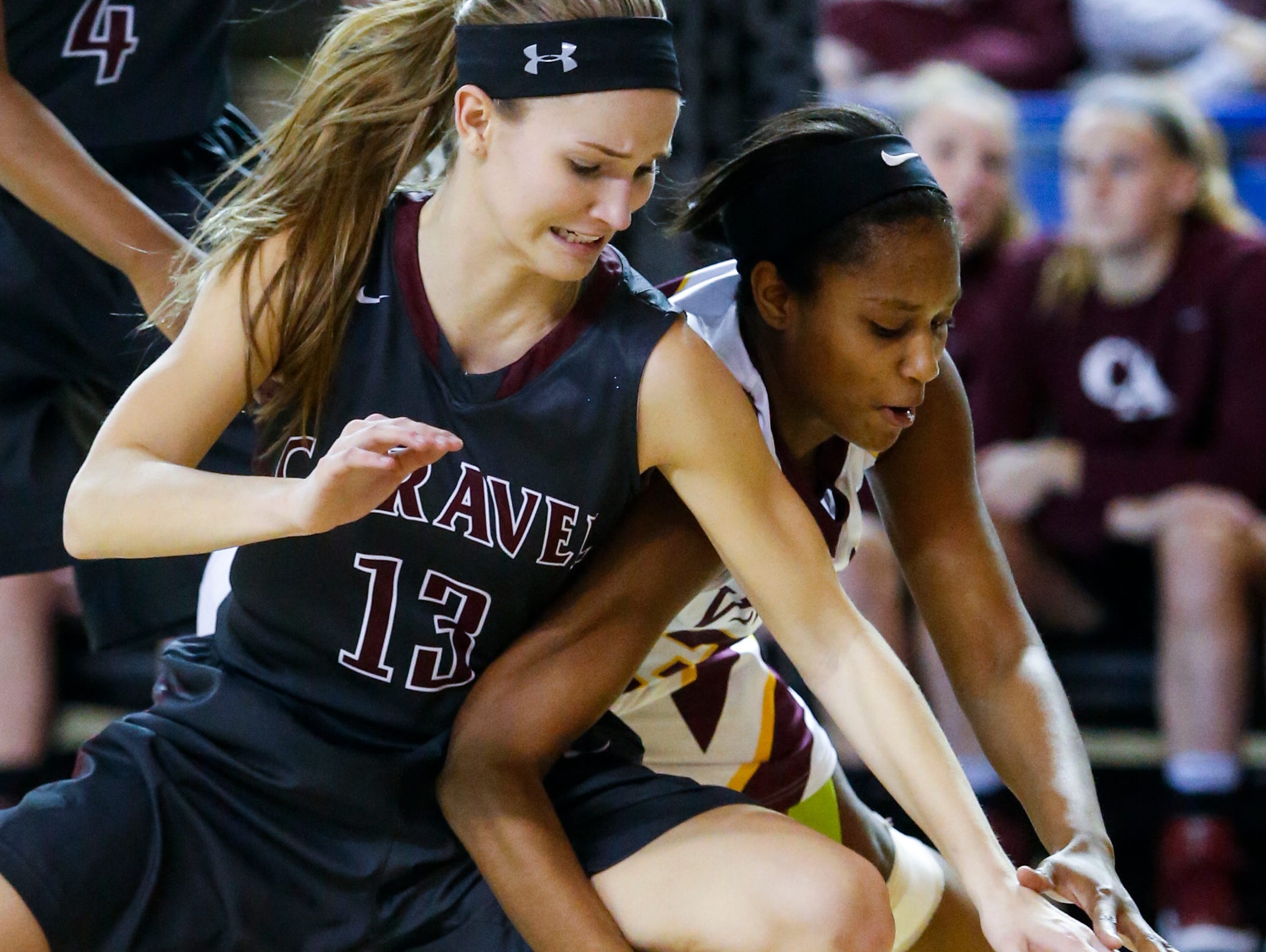 Caravel's Grace Lange (left) clashes with St. Elizabeth's Alanna Speaks for a loose ball in the first half of a DIAA state tournament semifinal Wednesday.