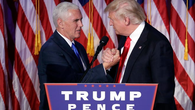 President-elect Donald Trump shakes hands with Vice President-elect Mike Pence as he gives his acceptance speech during his election night rally, Wednesday, Nov. 9, 2016, in New York.