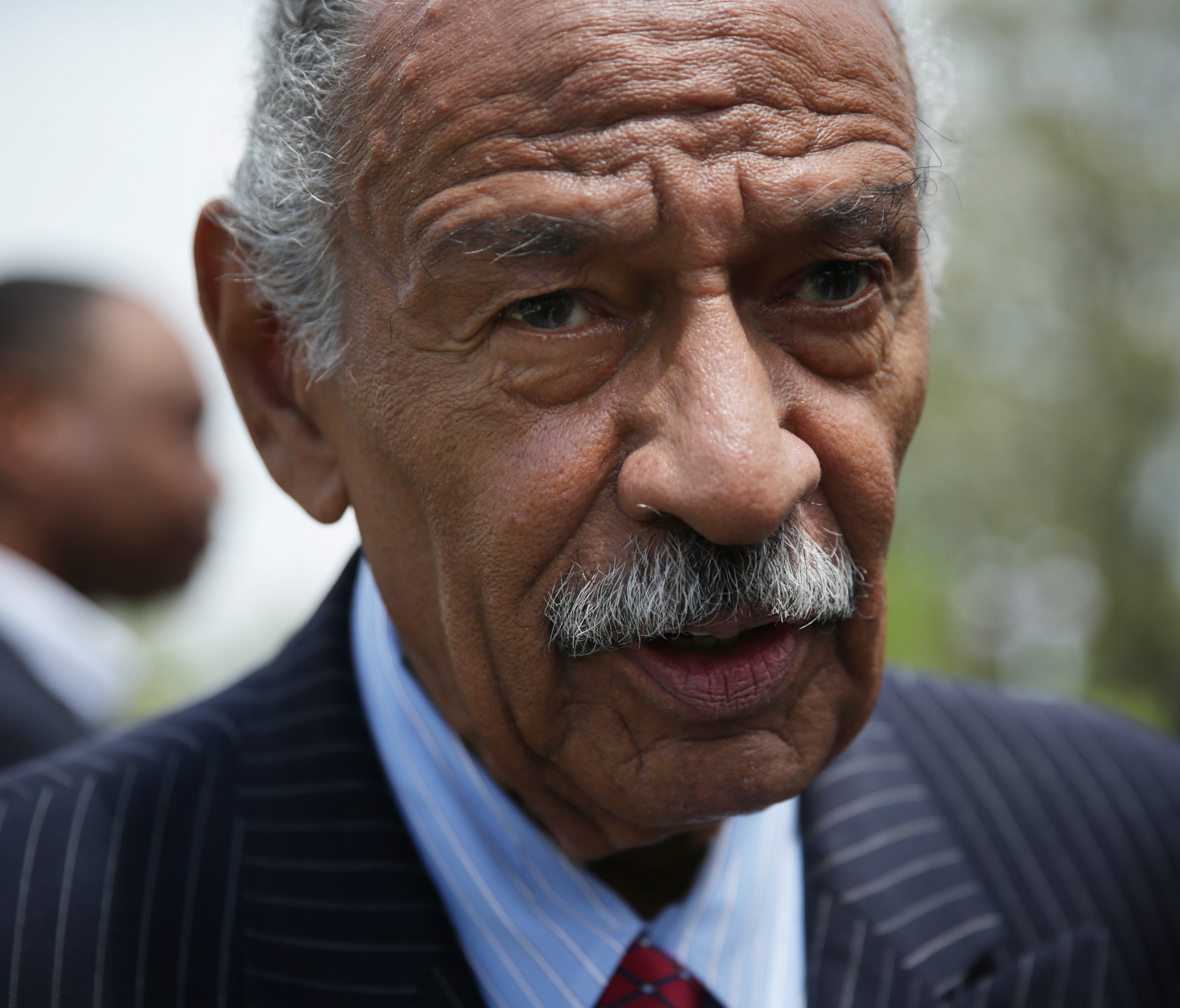 Rep. John Conyers speaks to a reporter at the end of a news conference April 22, 2015 on Capitol Hill in Washington, DC.