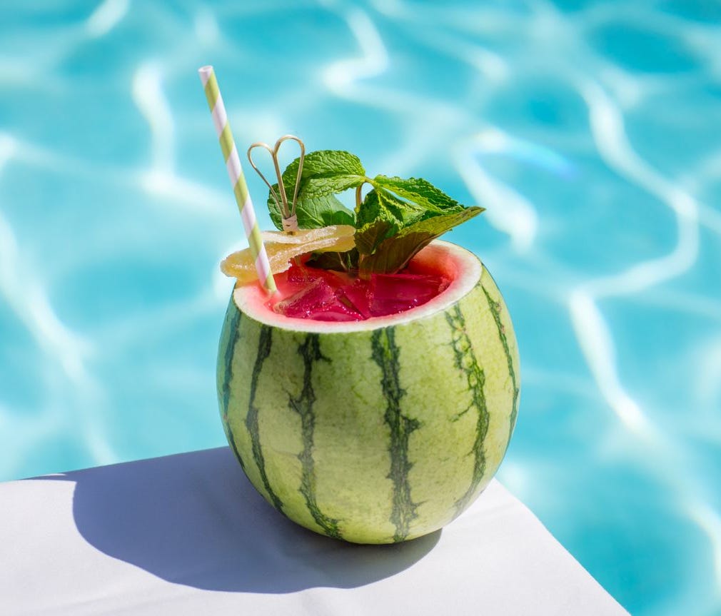 The Aquatic Club at The Palazzo Las Vegas serves Tee Time with Absolut Lime, fresh watermelon juice, lime juice, mint syrup and pok pok ginger on ice in a cored out watermelon with a mint leaf.