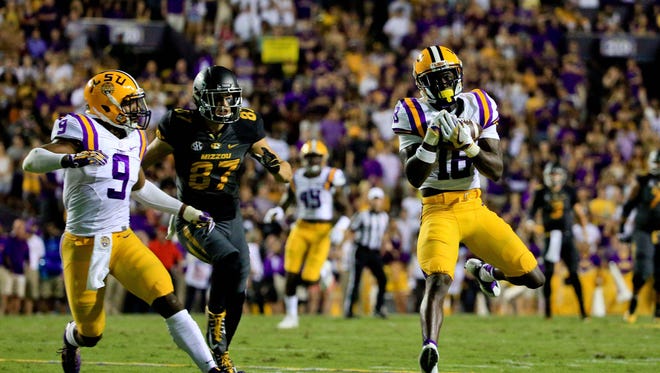 LSU Tigers cornerback Tre'Davious White (18) intercepts a pass against the Missouri Tigers during the first half of a game at Tiger Stadium.