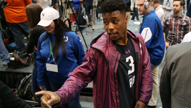 Mar 1, 2018; Indianapolis, IN, USA; Penn State Nittany Lions running back Saquon Barkley is escorted from the stage after completing his media interview during the 2018 NFL Combine at the Indianapolis Convention Center. Mandatory Credit: Brian Spurlock-USA TODAY Sports