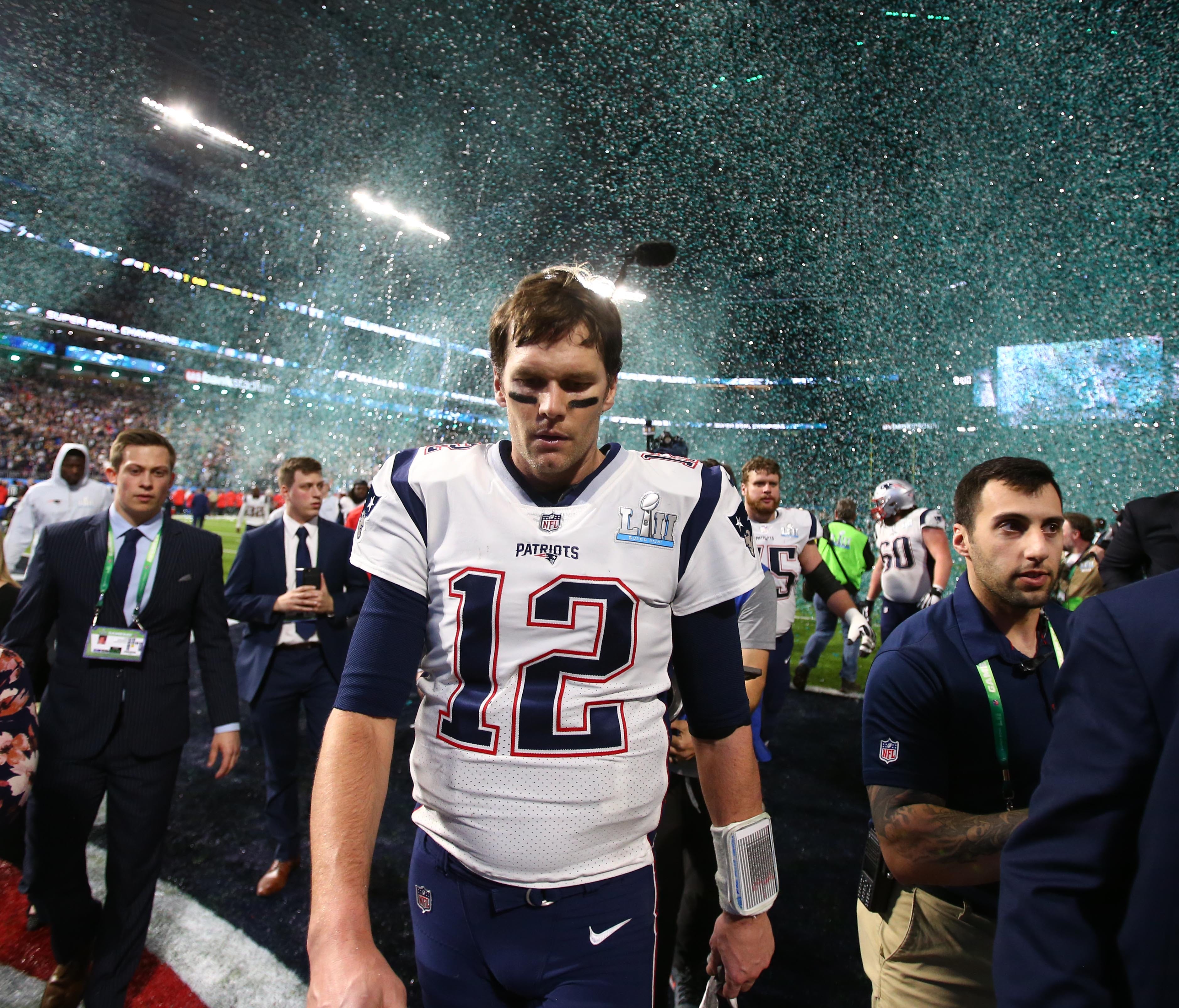 New England Patriots quarterback Tom Brady (12) walks off the field after Super Bowl LII against the Philadelphia Eagles at U.S. Bank Stadium.