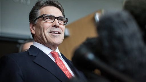 Former Texas Gov. Rick Perry, shown in November 2014, answers questions  following a hearing on felony abuse of power charges at the Blackwell-Thurman Criminal Justice Center, in Austin, Texas. He says the case won't alter his preparations for a possible run for president in 2016.