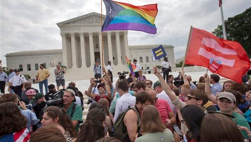 The crowd reacts as the Supreme Court's ruling on same-sex marriage is announced outside of the Supreme Court in Washington. The Supreme Court declared Friday that same-sex couples have a right to marry anywhere in the U.S.
