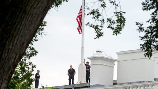 The American flag is lowered to half-staff above the White House in Washington, Tuesday, July 21, 2015, to honor the five U.S. service members who were killed by a gunman in Chattanooga, Tenn. last week. President Obama has ordered flags at all military and federal buildings and grounds through out the United States to remain at half-staff through July 25th. (AP Photo/Andrew Harnik)