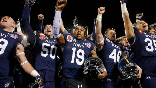 Navy quarterback Keenan Reynolds (19) sings the U.S. Naval Academy fight song alongside teammates after the Military Bowl against Pittsburgh on Monday. Navy won 44-28.
