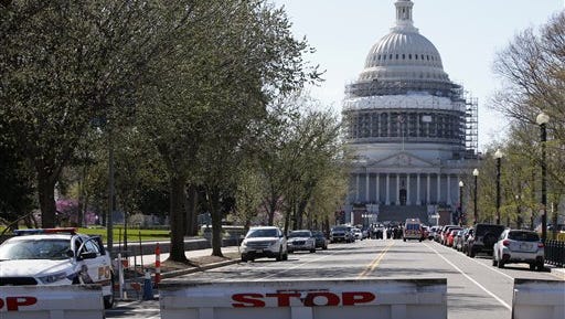 A street leading to Capitol Hill in Washington is closed, Monday, March 28, 2016, after reports of gunfire at the Capitol Visitor Center complex. (AP Photo/Alex Brandon
