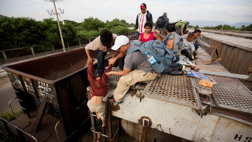 FILE  - In this Saturday, July 12, 2014 file photo, a young boy is helped down from a freight car as Central American migrants board a northbound freight train in Ixtepec, Mexico. The Rocky Mountain states have taken in less than 1 percent of the more than 100,000 unaccompanied minors who crossed the border from El Salvador, Guatemala and Honduras since the fall of 2013.
The bulk  860  have ended up in Colorado.  (AP Photo/Eduardo Verdugo, File)