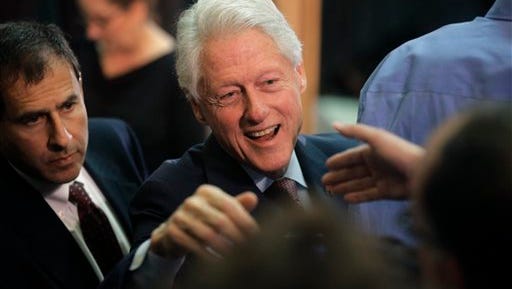 Former President Bill Clinton greets people in the audience after speaking in support of his wife, Democratic presidential candidate Hillary Clinton, Thursday, April 14, 2016, at the Community College of Rhode Island, in Warwick, R.I. (AP Photo/Steven Senne)