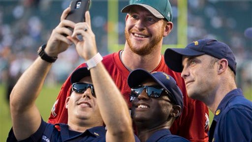 Eagles quarterback Carson Wentz poses with fans during an Eagles' practice that was open to the public last month.