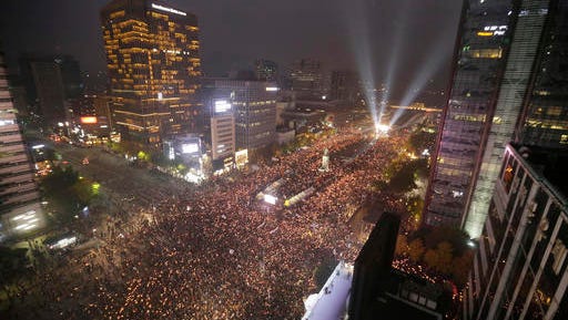 In this Saturday, Nov. 5, 2016 photo, South Korean protesters stage a rally calling for South Korean President Park Geun-hye to step down in downtown Seoul, South Korea. South Korea is seeing its biggest wave of street demonstrations in decades but nobody is sure how many people are taking to the streets each week. At first media relied on two sources - the police and the organizer. But they have been accused of underestimating or overestimating the crowds in the previous four Saturdays.