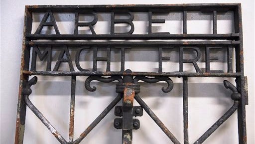 The iron gate from the former Nazi concentration camp in Dachau, southern Germany, with the slogan "Arbeit macht frei" ("Work will set you free") is displayed Saturday Dec. 3, 2016, after being found earlier this week by police in Bergen, Norway.  The infamous wrought iron gate was stolen two years ago, and is being cared for by police in Bergen before being returned to Germany.