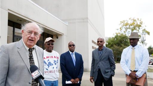 Montgomery attorney, Julian McPhillips, left, speaks to the press on Tuesday, Oct. 14, 2014, in Montgomery, Ala. McPhillips announced that he filed a lawsuit Tuesday against longtime pastor Juan D. McFarland.The Shiloh Missionary Baptist Church wants to remove McFarland after being accused of having sex with the congregation members while infected with AIDS. (AP Photo/Brynn Anderson)
