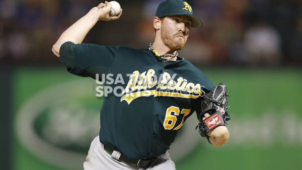 Oakland Athletics starting pitcher Dan Straily (67) throws a pitch in the third inning of the game against the Texas Rangers at Rangers Ballpark in Arlington.