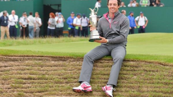 Rory McIlroy sets on the lip of a pot bunker as he poses with the claret jug after winning the British Open at Royal Liverpool on Sunday.