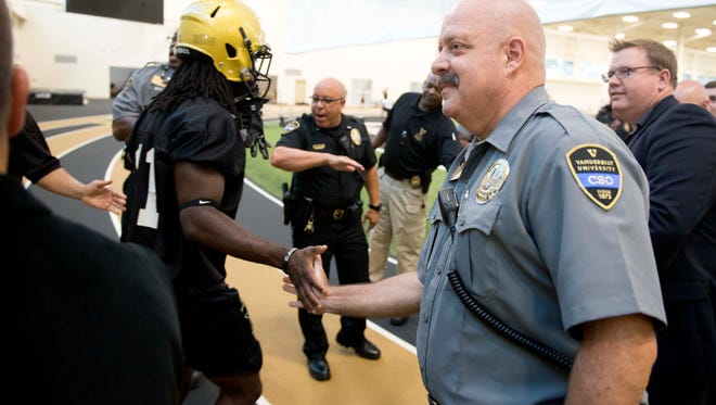 Vanderbilt community service officer Tony Meyer greets Vanderbilt football players before the first practice of the preseason on Aug. 4, 2016.