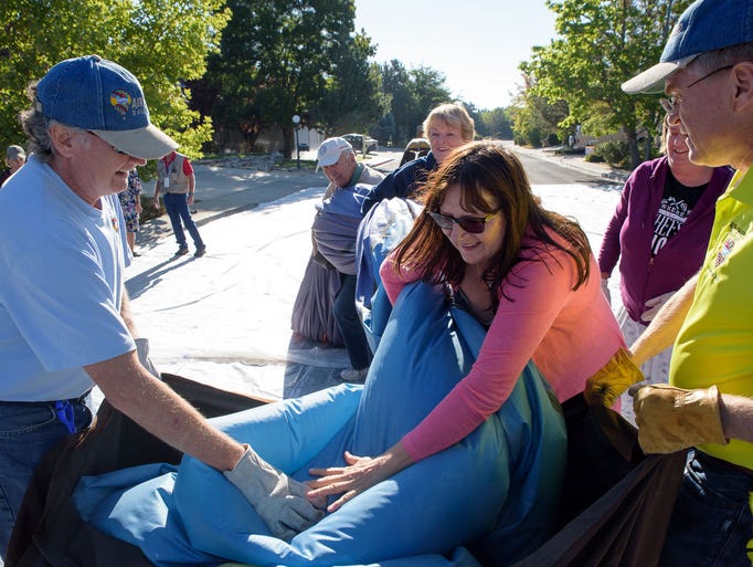 Arika Vogel, center, and other neighborhood women help