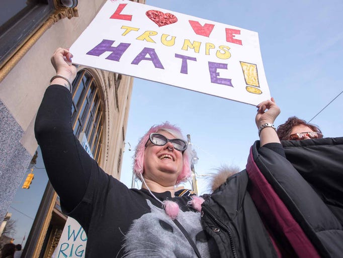 Tracey Goldie, 47, of Hamtramck, holds her sign high