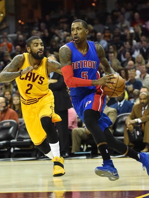 Pistons guard Kentavious Caldwell-Pope (5) dribbles as Cavaliers guard Kyrie Irving (2) defends during the first quarter Friday in Cleveland.