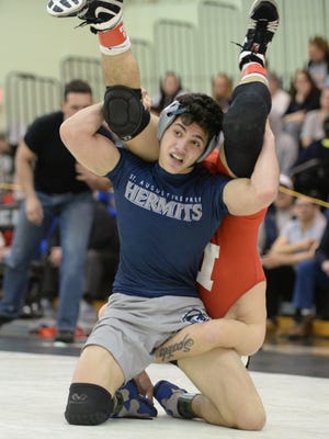 St. Augustine's Connor Kraus wrestles Delsea's Tim Spatola in a 138-pound bout at the Region 8 tournament last season. Both the Hermits and Crusaders are in The Mat Pack's preseason Mean 15 rankings.