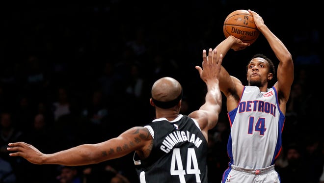 Pistons guard Ish Smith shoots over Nets forward Dante Cunningham during the first half Sunday in Brooklyn.