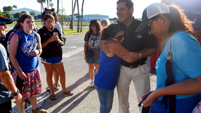 Joe Karabensh, president of Missionary Flights International, receives a hug from Kinsley Smith, of Agape to the Nations, on Tuesday, July 10, 2018 after Smith and 22 fellow missionaries land safely at Treasure Coast International Airport and Business Park in Fort Pierce. Smith and her group were serving on a mission trip in Haiti when riots broke out ending their trip early. Due to roads blocks and civil unrest, the group was unable to reach the main airport to evacuate, when they were able to coordinate with Missionary Flights International to get out of the country. "By God's beautiful, just how he aligns everything, we were able to use Missionary Flights International to get this team out today," Smith said. "It truly has been a relief and a breath of fresh air that we can step on U.S. soil today. But, we do miss our friends in Haiti and we are praying for them for peace because they are our family and friends there too."