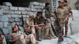 Members of the Iraqi forces rest in Mosul's northwestern