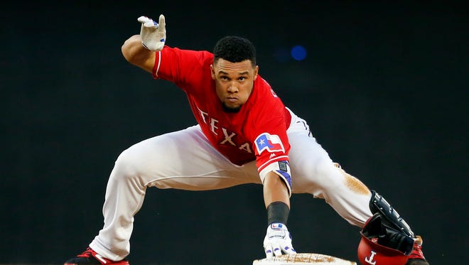 Texas Rangers' Carlos Gomez calls for time after recovering from his slide into second on a double off Kansas City Royals' Danny Duffy during the third inning of a baseball game in Arlington, Texas, on Thursday.