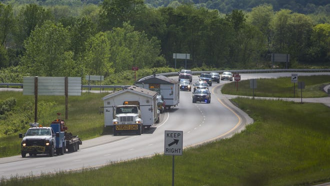 May 12, 2016: Two of the four homes where members of the Rhoden family were shot and killed on the morning of April 22 are transported along State Route 32 from the Union Hill Road properties to a warehouse in Waverly, which was being used as a command center for authorities.