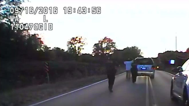 In this image made from a Friday, Sept. 16, 2016 police video, Terence Crutcher, center, is pursued by police officers as he walk to an SUV in Tulsa, Okla. Crutcher was taken to the hospital where he was pronounced dead after he was shot by the officer around 8 p.m., Friday, police said. Crutcher had no weapon on him or in his SUV, Tulsa Police Chief Chuck Jordan said Monday, Sept. 19, 2016.