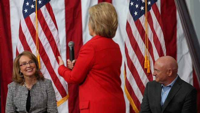 Gabby Giffords and her husband, Mark Kelly, look on as Hillary Clinton speaks at Iowa State University on Jan. 30, 2016 in Ames.