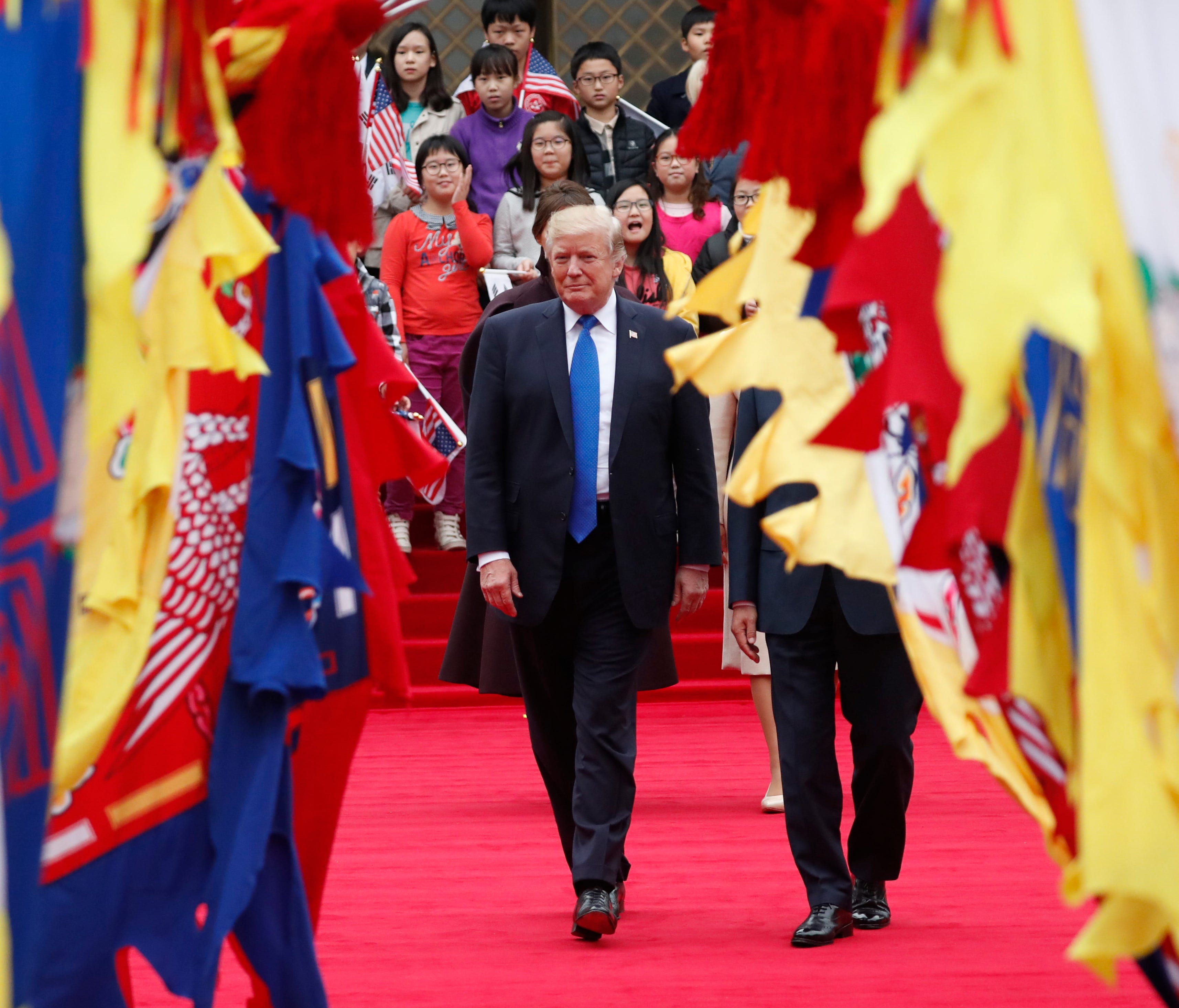 President Trump walks with South Korea's President Moon Jae-in during a welcoming ceremony at the Presidential Blue House in Seoul.