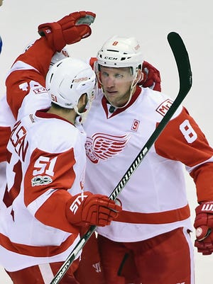 Red Wings forward Justin Abdelkader (8) celebrates with Red Wings forward Frans Nielsen (51) after scoring against Canucks goaltender Ryan Miller (not pictured) during overtime of the Wings' 3-2 overtime win Tuesday in Vancouver, B.C.