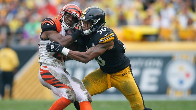 Cincinnati Bengals running back Giovani Bernard (25) is tackled by Pittsburgh Steelers inside linebacker Ryan Shazier (50) in the second quarter during the Week 2 NFL football game between the Pittsburgh Steelers and the Cincinnati Bengals, Sunday, Sept. 18, 2016, at Heinz Field in Pittsburgh. At the half, Pittsburgh led, 10-6.
