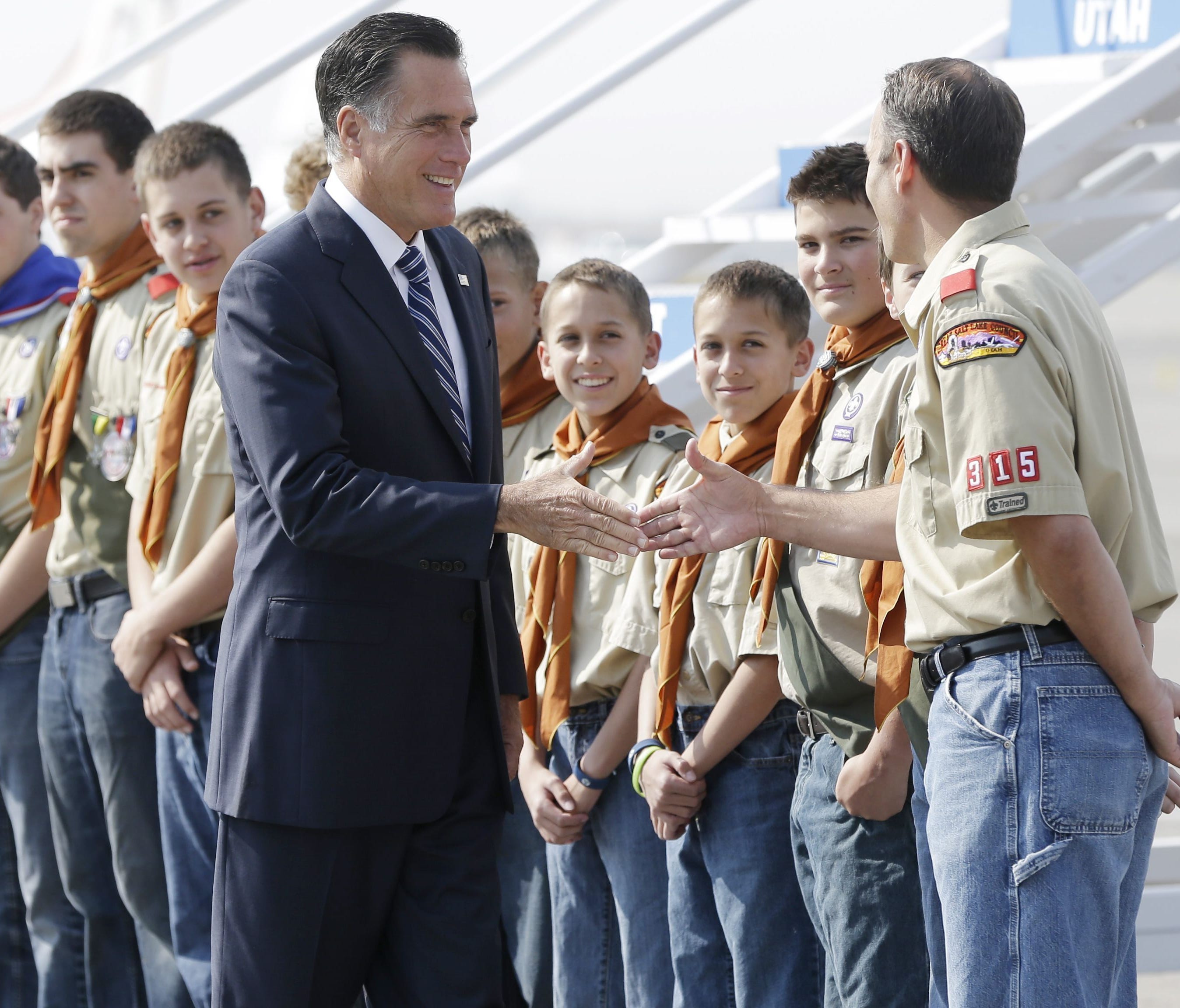 Republican presidential candidate and former Massachusetts Gov. Mitt Romney greets boy scouts as he arrives in Salt Lake City, Utah, Sept. 18, 2012.