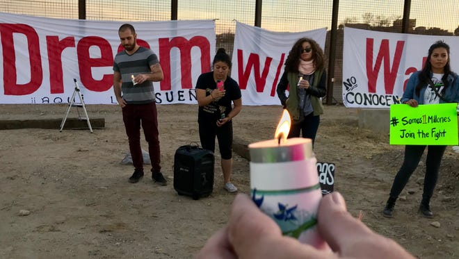 About 25 people hold a candlelight vigil as they urge solidarity to resist militarization along the U.S.-Mexico border and demand that Congress move on a clean Dream Act without provisions for a border wall. The immigrant rights movement Movimiento Cosecha Texas, area artists and groups from El Paso, Canutillo, Juárez and Las Cruces took part in the protest at 1720 W. Paisano Drive. The group sang and lit candles and hung a banner saying, “Dream w/o walls” on the border barrier.