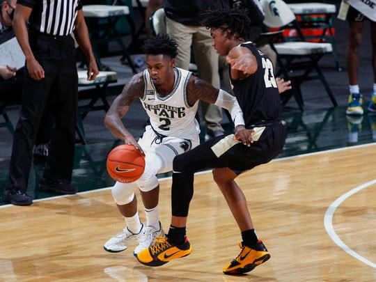 Michigan State's Rocket Watts, left, maneuvers against Purdue's Jaden Ivey (23) during the first half of an NCAA college basketball game Friday, Jan. 8, 2021, in East Lansing, Mich. (AP Photo/Al Goldis)