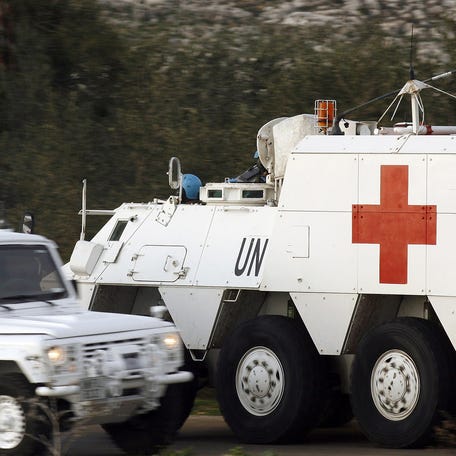 Spanish soldiers of the United Nations Interim Force in Lebanon (UNIFIL) drive an armoured emergency vehicle after picking up the body of a 36-year-old UN peacekeeper from Spain who was killed as the Israeli military shelled border areas following a Hezbollah attack that left two Israeli soldiers dead, in the southern Lebanese village of Abbassiyeh near to the disputed Israeli-occupied Shebaa Farms area, on January 28,   2015. The soldier was part of the 10,000-strong United Nations peacekeeping force in southern Lebanon (UNIFIL), which includes 600 Spanish soldiers. AFP PHOTO/MAHMOUD ZAYYATMAHMOUD ZAYYAT/AFP/Getty Images ORIG FILE ID: 537247604