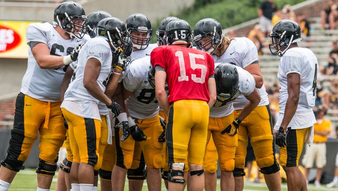 Jake Rudock (15) directs the Iowa offense during a practice session at Kinnick Stadium   on Saturday. The junior quarterback accounted for five of the Hawkeyes' 17 rushing scores in the red zone last season.