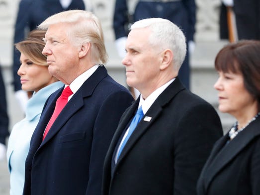 The Trumps and Pences stand on the east front steps
