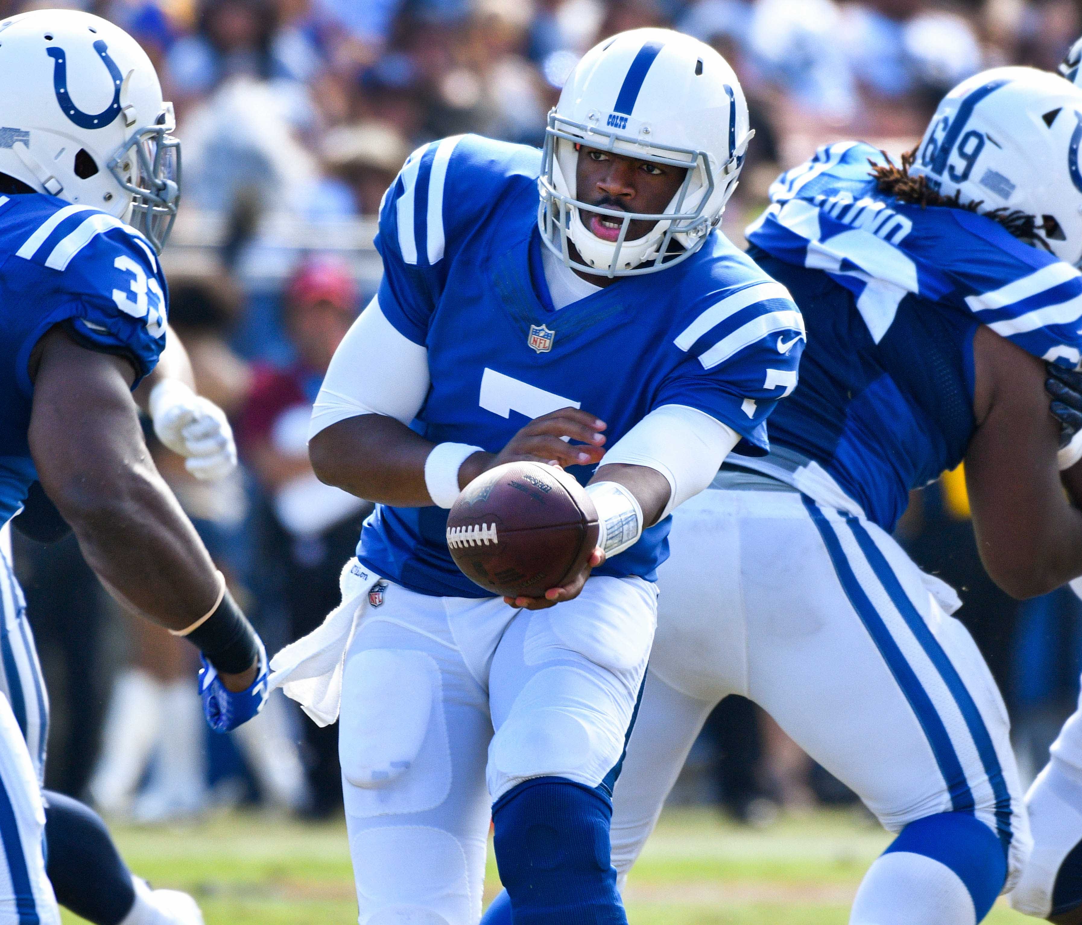 Indianapolis Colts quarterback Jacoby Brissett hands off the ball to running back Robert Turbin (33) during the second half against the Los Angeles Rams at Los Angeles Memorial Coliseum.