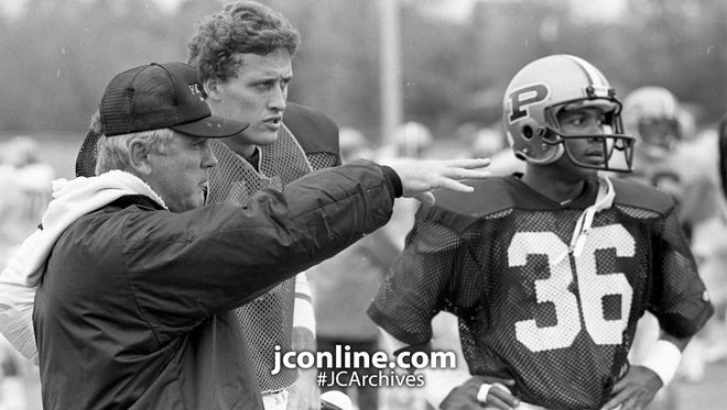 Purdue's offensive coordinator Bob Spoo gives instructions to quarterback Jim Everett. Photo taken Nov. 5, 1985.