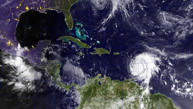 A handout photo made available by the U.S. Navy shows a GOES satellite image of Hurricanes Jose (top) in the Atlantic Ocean and Maria in the Caribbean Sea on Sept. 18, 2017.