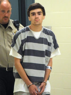 Julian Nico Gourley, 18, is escorted into Minnehaha County Jail on Friday, July 10, to face charges in connection to a shooting on June 28.