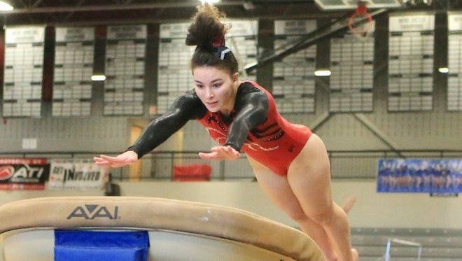 Canton High School gymnast Katherine Najduk, attempting a vault, is among the athletes competing in the 2017 MHSAA gymnastics state championships.